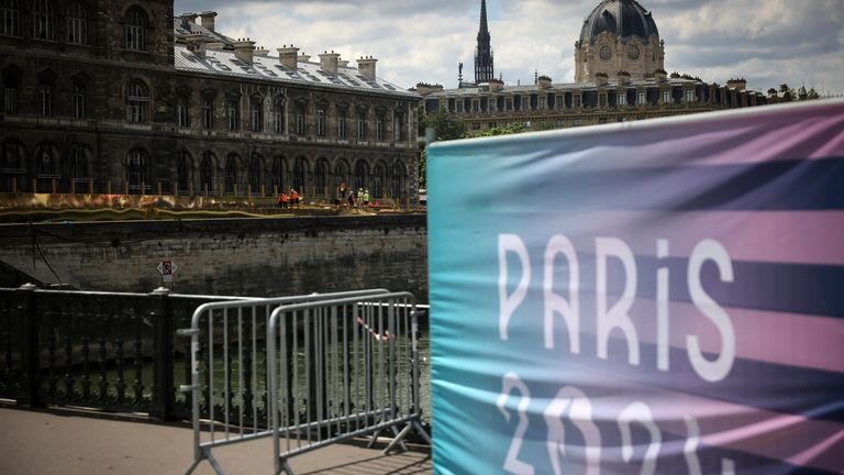 Workers operate along the Seine river at the 2024 Summer...