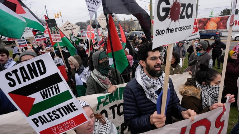Pro-Palestinian demonstrators march during a visit by President Joe Biden...