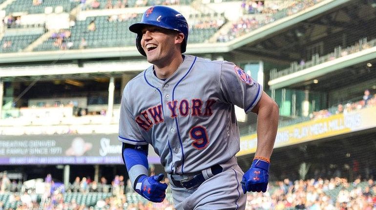 Brandon Nimmo of the Mets smiles as he celebrates after...