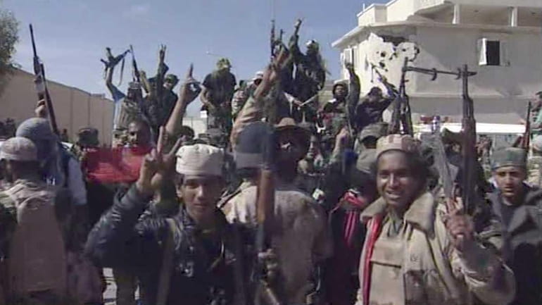 Libyan fighters celebrate in the streets of Sirte Libya in...