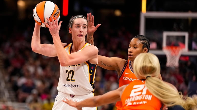 Indiana Fever guard Caitlin Clark (22) looks to pass over...