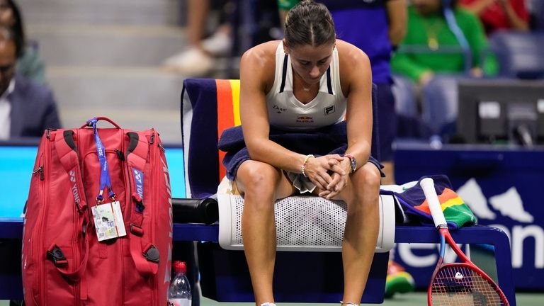 Emma Navarro, of the United States, takes a break between...