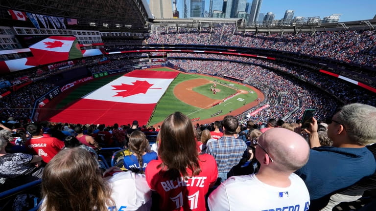 Fans look on as a huge Canadian flag is unfurled...