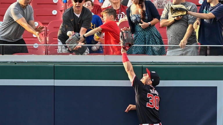 Washington Nationals center fielder Jacob Young (30) leaps but cannot...