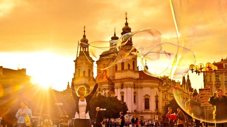 Prague's Baroque Old Town Square is alive with street performers,...