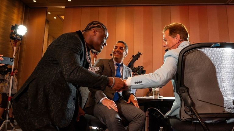 Alabama quarterback Jalen Milroe greets former Alabama coach Nick Saban...