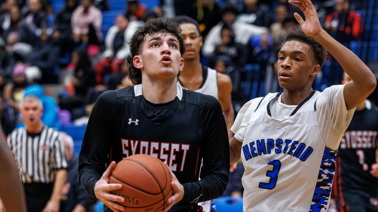 AJ AbuSaab of Syosset looks to score past Tyreek Wyllie of...