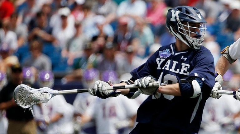 Yale's Jack Tigh works against Albany during the first half...