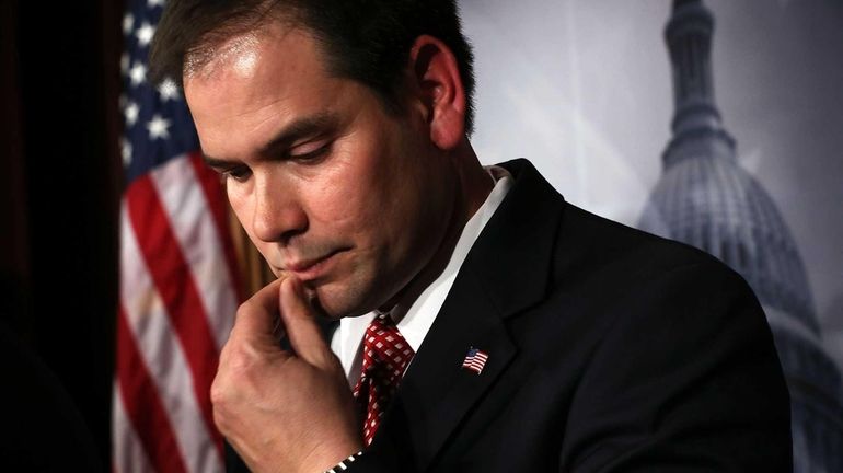 Sen. Marco Rubio listens during a news conference on a...