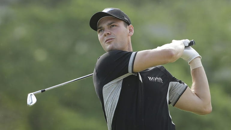 Martin Kaymer, of Germany, watches his tee shot on the...