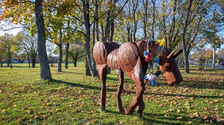 A sculpture at Fair Meadow Park greets visitors and cars...