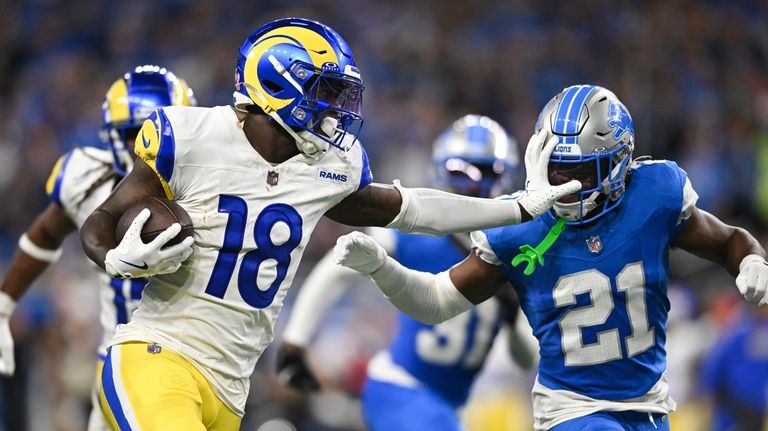 Los Angeles Rams wide receiver Tyler Johnson (18) stiff-arms Detroit...