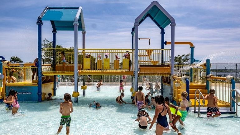 Children cool off at the spray park at Wantagh Park.