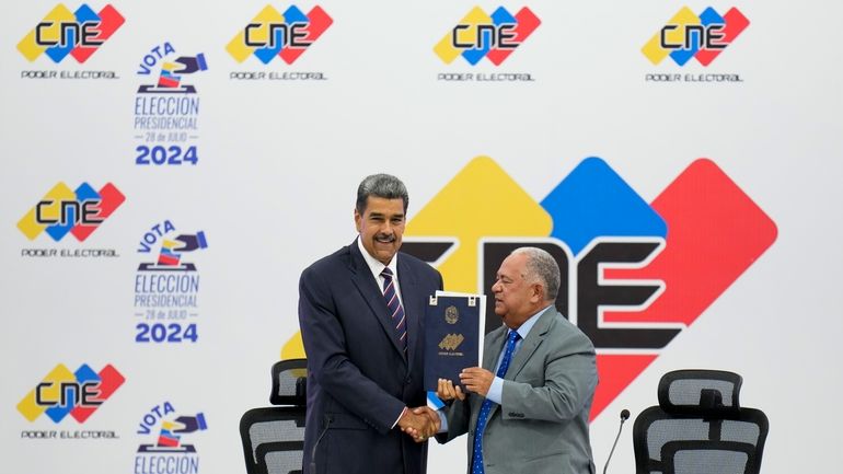 Venezuelan President Nicolas Maduro, left, receives certification from the President...