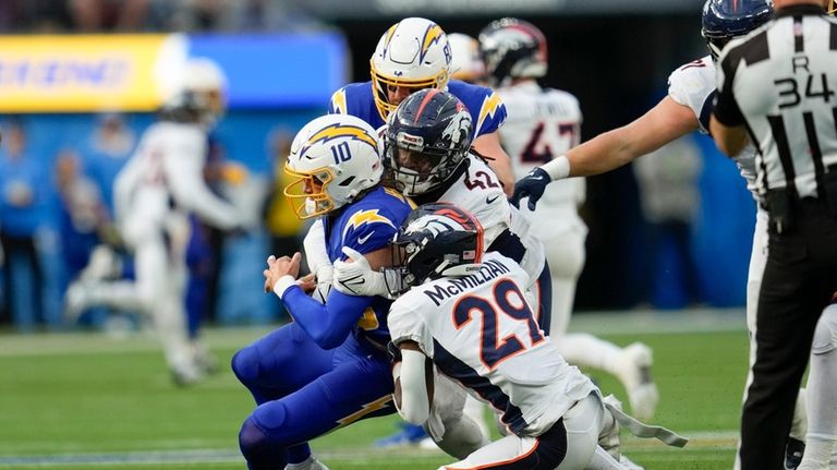 Los Angeles Chargers quarterback Justin Herbert (10) is sacked by...