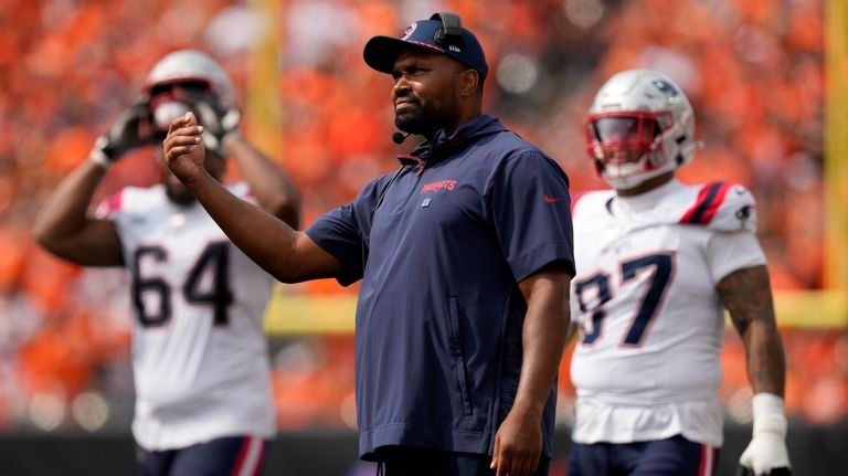 New England Patriots head coach Jerod Mayo watches from the...