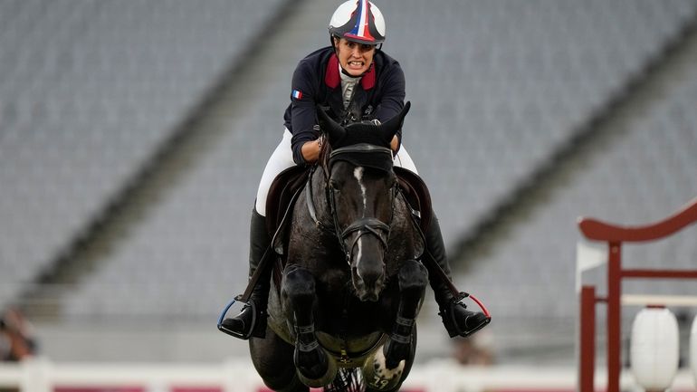 Elodie Clouvel of France competes in the horse jumping portion...