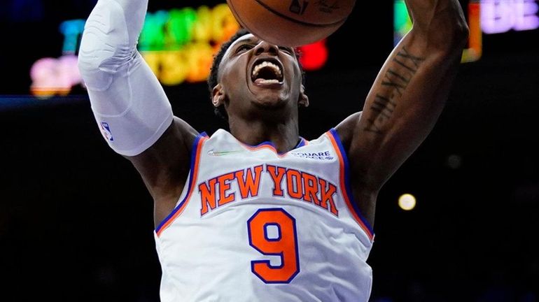 The Knicks' RJ Barrett dunks the ball during the first...