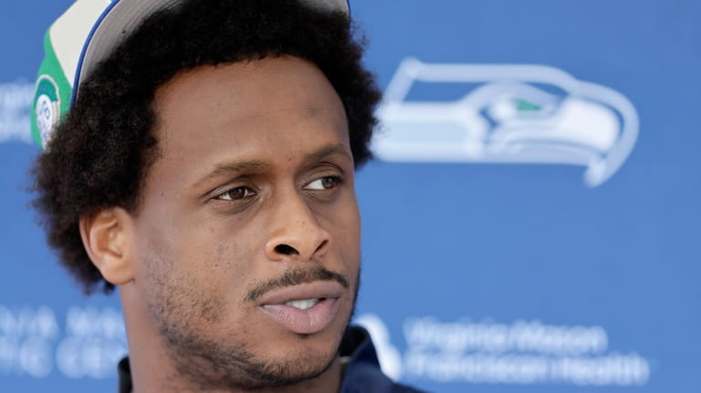 Seattle Seahawks quarterback Geno Smith talks with reporters after the...