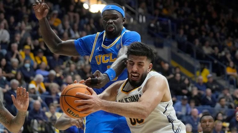 California forward Fardaws Aimaq, bottom, grabs a rebound in front...