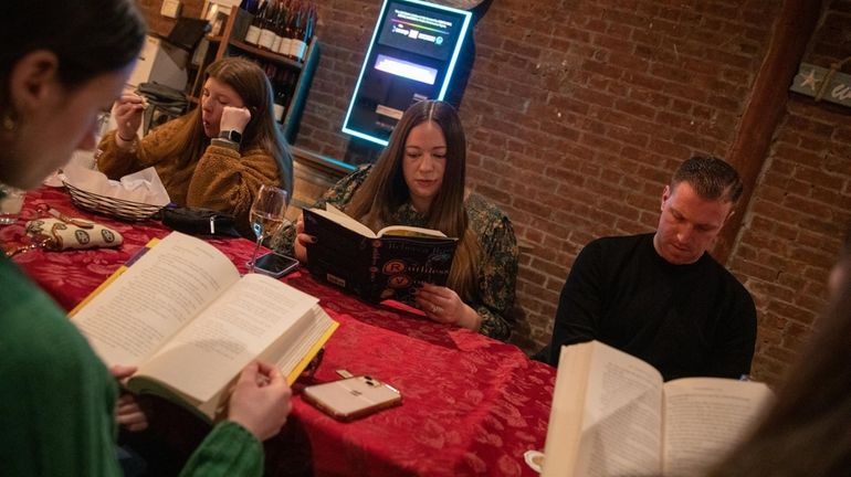 Brittany Gustavoson, of Garden City, reads a book at the...