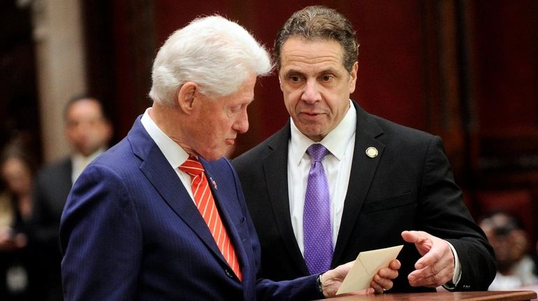 Former President Bill Clinton, left, and New York Gov. Andrew...