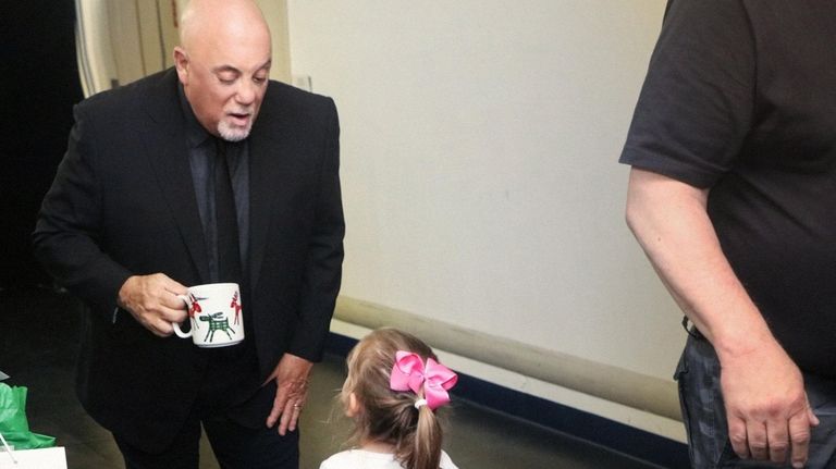 Joel talks to his daughter Della backstage at a recent...