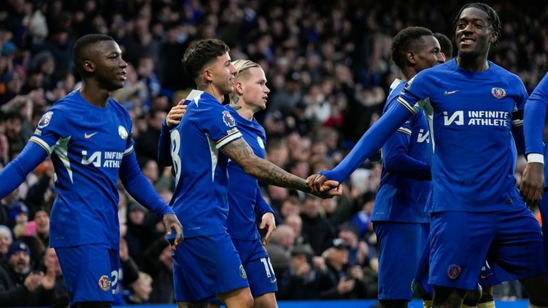 Chelsea's Enzo Fernandez, center, celebrates with his teammates after he...