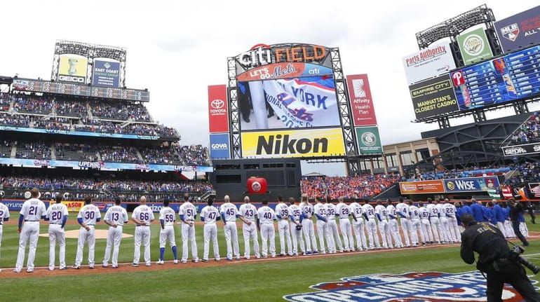 New York Mets players watch as the traditional Opening Day...