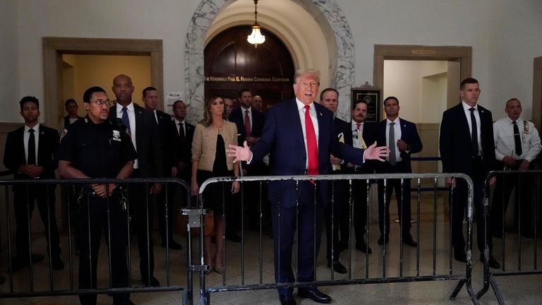 Former President Donald Trump speaks to reporters as he leaves...