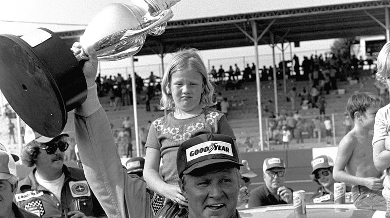 Cale Yarborough of Timmonsville S.C., holds his trophy high in...