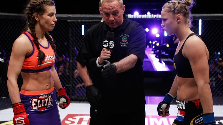 Ronda Rousey and Miesha Tate get instructions from the referee...