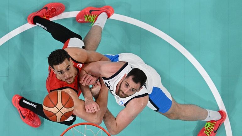 Georgios Papagiannis, of Greece, and Dwight Powell, of Canada, fight...