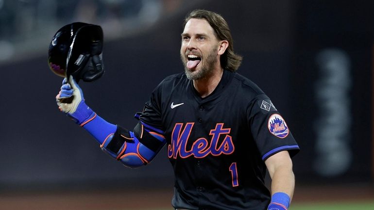 Jeff McNeil of the Mets celebrates his 10th-inning game-winning base hit...