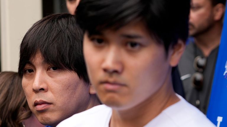 Ippei Mizuhara stands next to Japanese baseball star Shohei Ohtani...