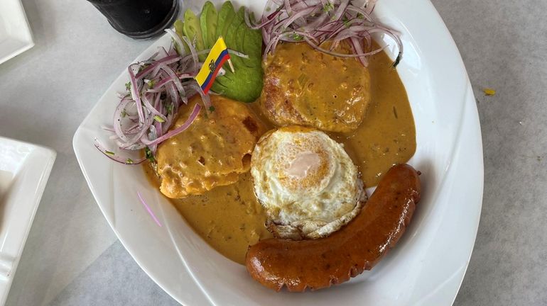 The Ecuadorian dish llapingachos with mashed potatoes and a peanut...