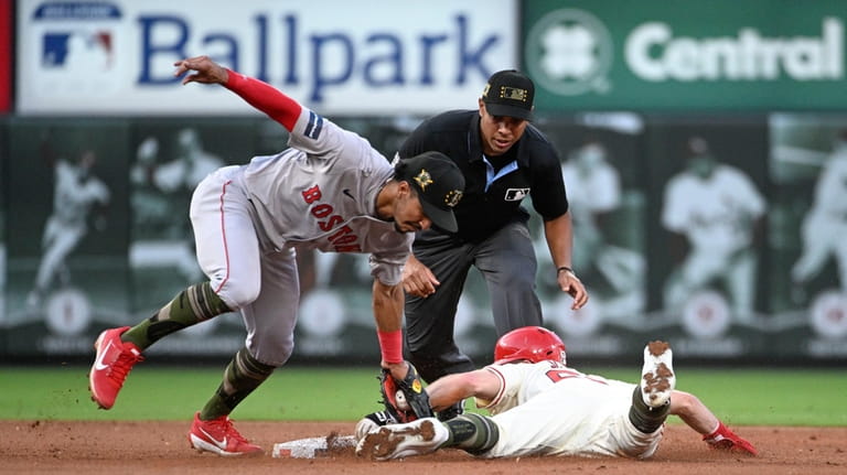 St. Louis Cardinals' Michael Siani, right, is tagged out by...
