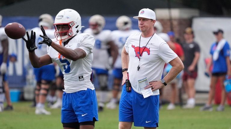 SMU's head football coach Rhett Lashlee, right, looks on as...