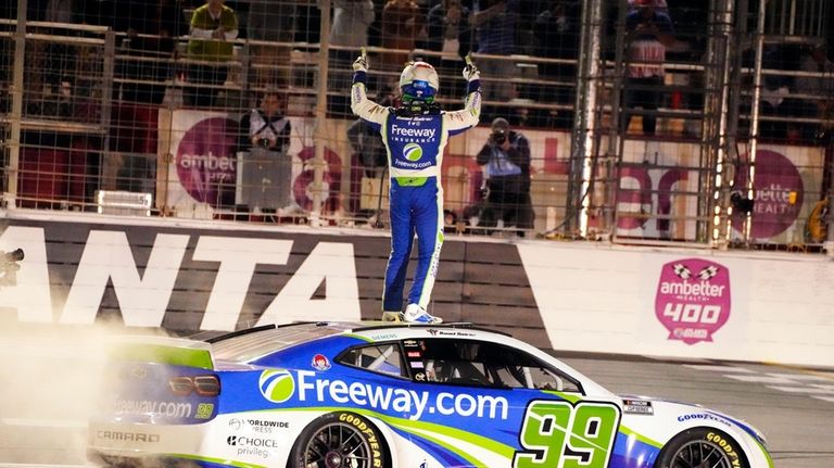 Daniel Suarez celebrates after winning the NASCAR auto race at...