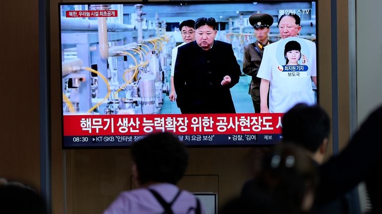 A TV screen shows an image of North Korean leader...