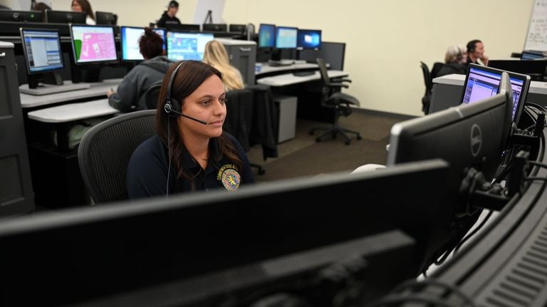 Nassau County Police communications bureau operators in Westbury Thursday.