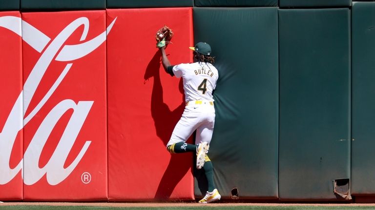 Oakland Athletics outfielder Lawrence Butler (4) catches a fly ball...