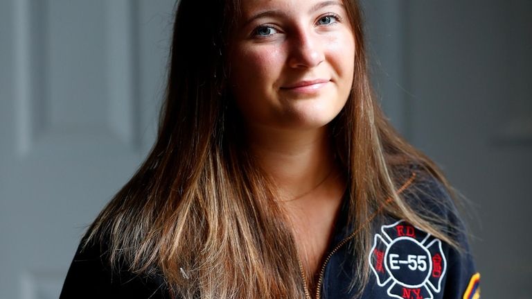 Capri Yarosz holds a photo of New York firefighter Christopher...