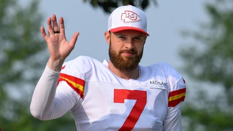 Kansas City Chiefs kicker Harrison Butker waves to the fans...