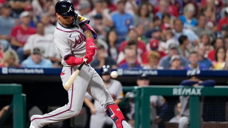 Atlanta Braves' Orlando Arcia hits a home run against Philadelphia...