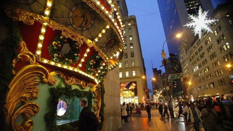 A pedestrian looks inside a Tiffany's window in Manhattan.The city's...