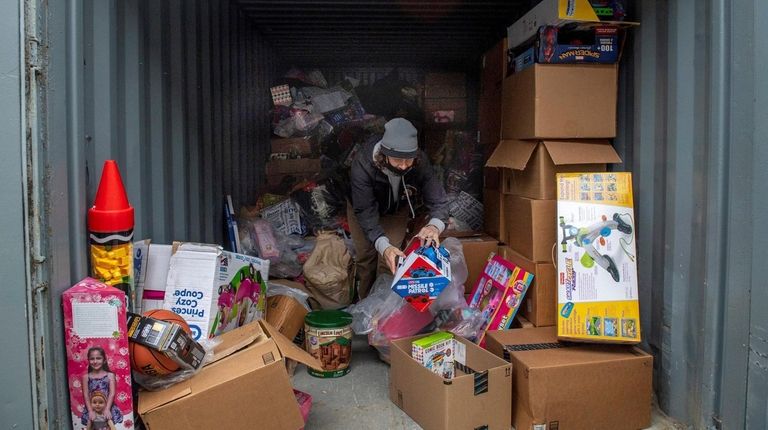 John Theissen organizes items at his foundation's Wantagh hub on Wednesday.