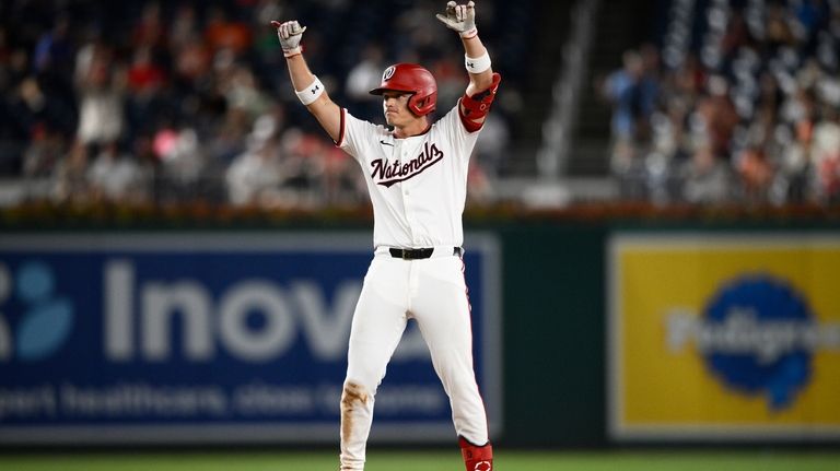 Washington Nationals' Alex Call gestures as he stands on second...