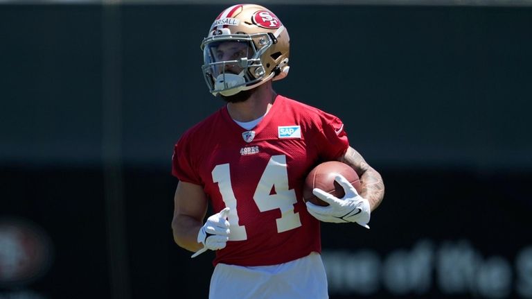 San Francisco 49ers wide receiver Ricky Pearsall carries the ball...