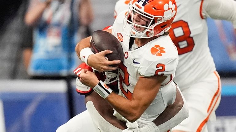 Clemson quarterback Cade Klubnik (2) is tackled by Georgia linebacker...